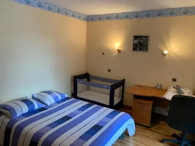 a bedroom with a bed and a desk and a desk at Villa avec piscine, jardin de 8000m2, cuisine extérieur à 20min de Carcassonne in Arzens