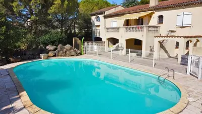 a large swimming pool in front of a house at Villa avec piscine, jardin de 8000m2, cuisine extérieur à 20min de Carcassonne in Arzens