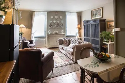 a living room with a couch and a table at Maison 1888 Carcassonne - Roof Terrace & Cité Views in Carcassonne