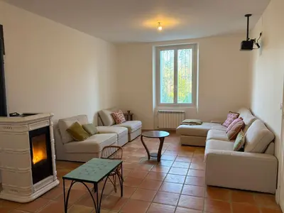 a kitchen with a stove and white cabinets at Maison familiale face au lac de Saint-Ferréol in Revel