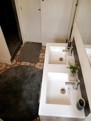 a bathroom with two white sinks and a hallway at Maison cosy au coeur du Pays Cathare - Corbières in Cascastel-des-Corbières