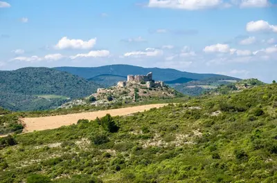 a castle on top of a hill with mountains at Maison cosy au coeur du Pays Cathare - Corbières in Cascastel-des-Corbières