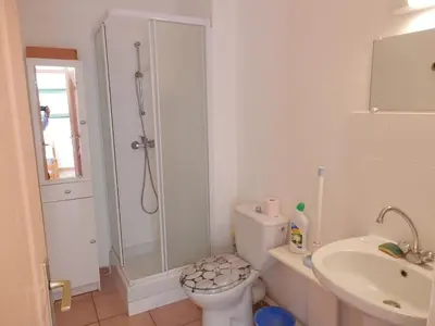 a bathroom with a shower and a toilet and a sink at Villa confortable, parking, animaux OK - 6 pers. - FR-1-796-109 in Gruissan
