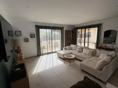 a bedroom with a large bed with a wooden floor at Maison- Aude in Cuxac-dʼAude