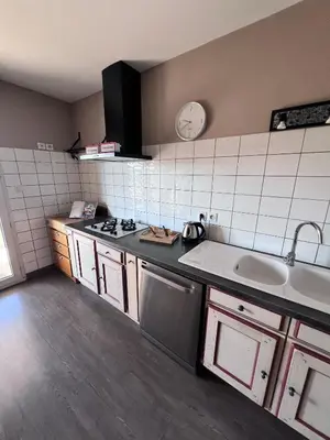 a kitchen with a sink and a stove top oven at Vue cité in Carcassonne