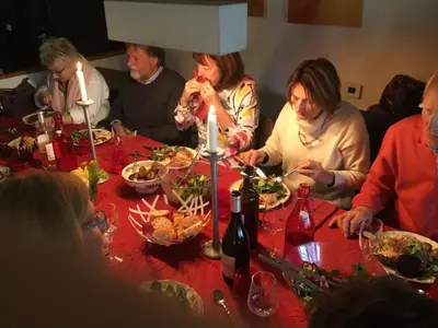 a group of people sitting around a table eating food at Schwanenvilla in Paraza