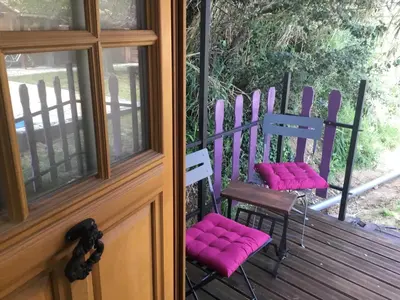 two chairs with pink cushions sitting on a porch at Schwanenvilla in Paraza
