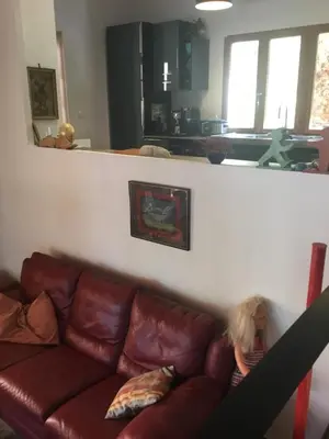 a little girl sitting on a couch in a living room at Schwanenvilla in Paraza