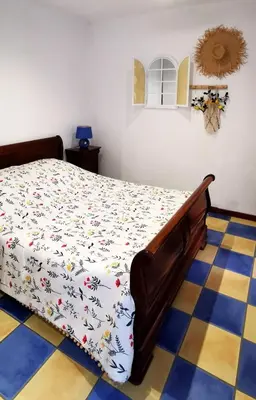 a bedroom with a bed with a white comforter at Domaine Vents Du Sud in Vingrau