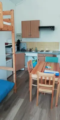 a kitchen with a table and chairs and a bunk bed at Domaine Vents Du Sud in Vingrau