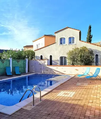 a swimming pool in front of a house at Domaine Vents Du Sud in Vingrau
