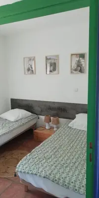 two twin beds in a room with two lamps at Domaine Vents Du Sud in Vingrau