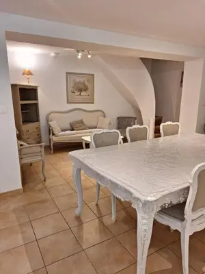 a living room with a white table and chairs at Le Relais De Pigasse in Ouveillan