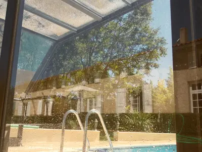 a view of a house from a window with a fountain at Gîte Belfloret in Renneville