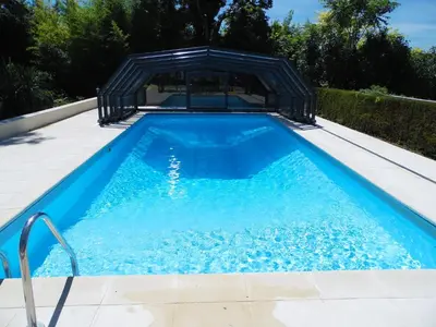 a swimming pool with a gazebo in a backyard at Gîte Belfloret in Renneville
