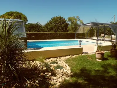 a swimming pool in a yard with a garden sidx sidx sidx at Gîte Belfloret in Renneville
