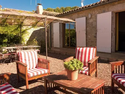 a patio with two chairs and a table with a tent at Sunny Escape to Serenity in Fraissé-des-Corbières