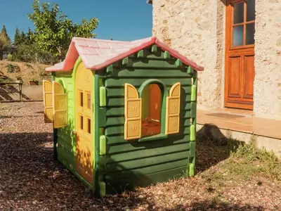 a green play house with a red roof at Sunny Escape to Serenity in Fraissé-des-Corbières
