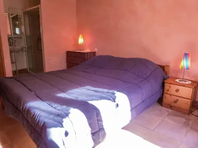a bedroom with a purple bed and two night stands at Sunny Escape to Serenity in Fraissé-des-Corbières