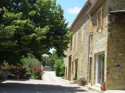 an alley in an old stone building with a tree at Villa in Conilhac with Private Terrace in La Serpent