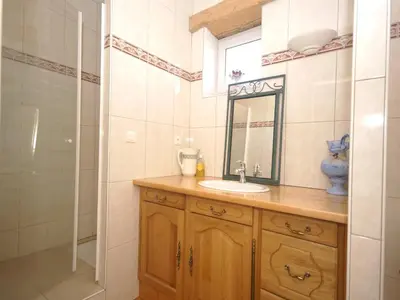 a bathroom with a sink and a mirror and a shower at Villa in Conilhac with Private Terrace in La Serpent