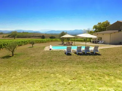 a pool with chairs and umbrellas in a field at Villa in Conilhac with Private Terrace in La Serpent