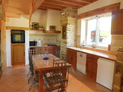 a kitchen with a table and a table and a window at Villa in Conilhac with Private Terrace in La Serpent