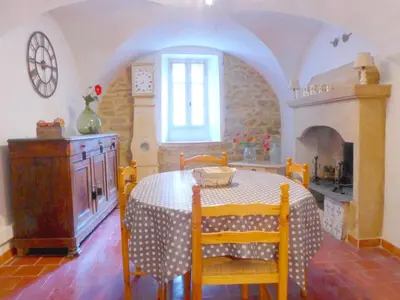 a kitchen with a table and a table and chairs at Village House in La Caunette with Pool in La Caunette