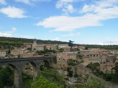 a city with a bridge and a town at Village House in La Caunette with Pool in La Caunette