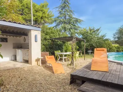 a backyard with a table and chairs and a swimming pool at Village House in La Caunette with Pool in La Caunette