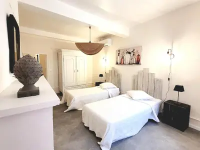 two beds in a room with white walls at Village House in La Caunette with Pool in La Caunette