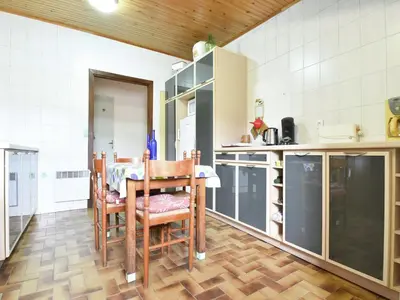 a kitchen with a table and chairs in a room at Holiday Home in Félines-Minervois with Pool in Félines-Minervois