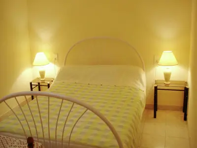 a bedroom with a bed with two lamps on two tables at Holiday Home in Félines-Minervois with Pool in Félines-Minervois