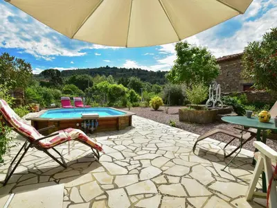 a patio with an umbrella and a swimming pool at Holiday Home in Félines-Minervois with Pool in Félines-Minervois