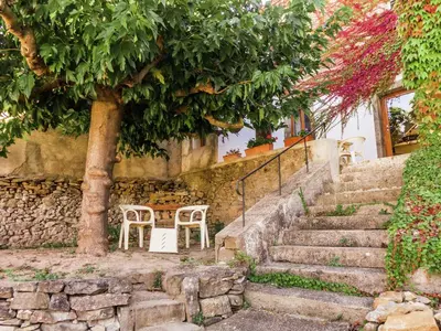 a set of stairs with two chairs and a tree at Holiday Home in Montbrun with Pool & Vineyards in Montbrun-des-Corbières