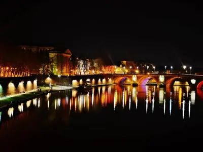a bridge over a body of water at night at Holiday Home in Montbrun with Pool & Vineyards in Montbrun-des-Corbières
