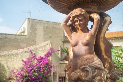 a statue of a boy holding his head at Vinauberge in Poilhès