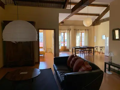 a living room with a couch and a table at Vinauberge in Poilhès