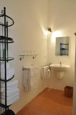 a bathroom with a sink and a mirror and towels at Vinauberge in Poilhès