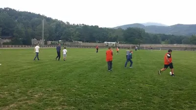 a group of people playing soccer on a field at Camping Le Pré Cathare in Lavelanet