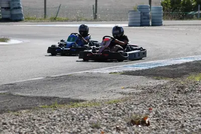 two people riding inailedailed cars on a road at Camping Le Pré Cathare in Lavelanet