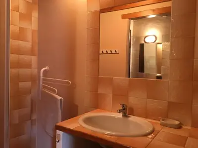 a bathroom with a sink and a mirror at Gite de Serrelongue in Montségur