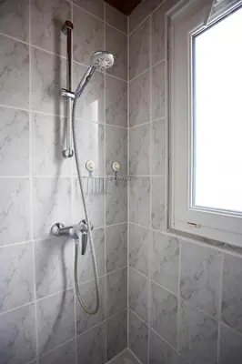 a shower with a shower head in a bathroom at Le Petit Viala in Capestang