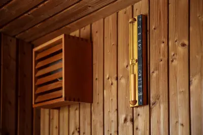 a wood paneled wall with a vent and a gun at Le Petit Viala in Capestang