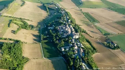 an aerial view of a house in the middle of a field at Les Roulottes Du Lauragais in Montmaur