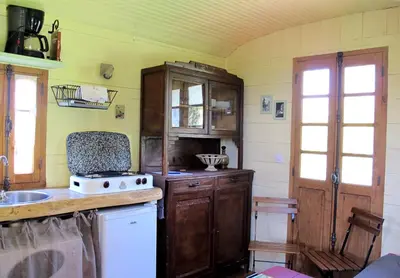 a kitchen with a sink and a stove top oven at Les Roulottes Du Lauragais in Montmaur