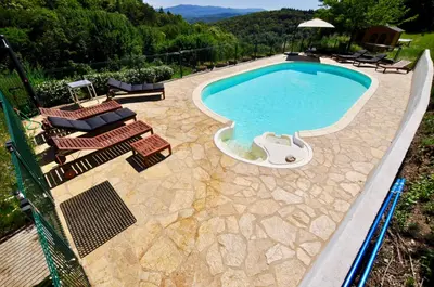 an overhead view of a swimming pool with some chairs at Les Coumayres in Riols