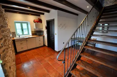 a kitchen with a staircase leading to a kitchenasteryasteryasteryasteryasteryasteryastery at Les Coumayres in Riols