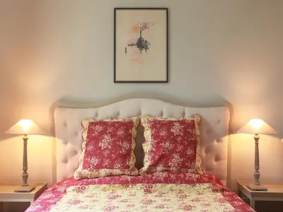 a bedroom with a bed with two lamps at Château de la Prade in Bram