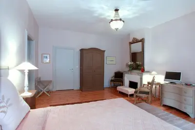 a bedroom with a bed and a desk and a mirror at Château de la Prade in Bram